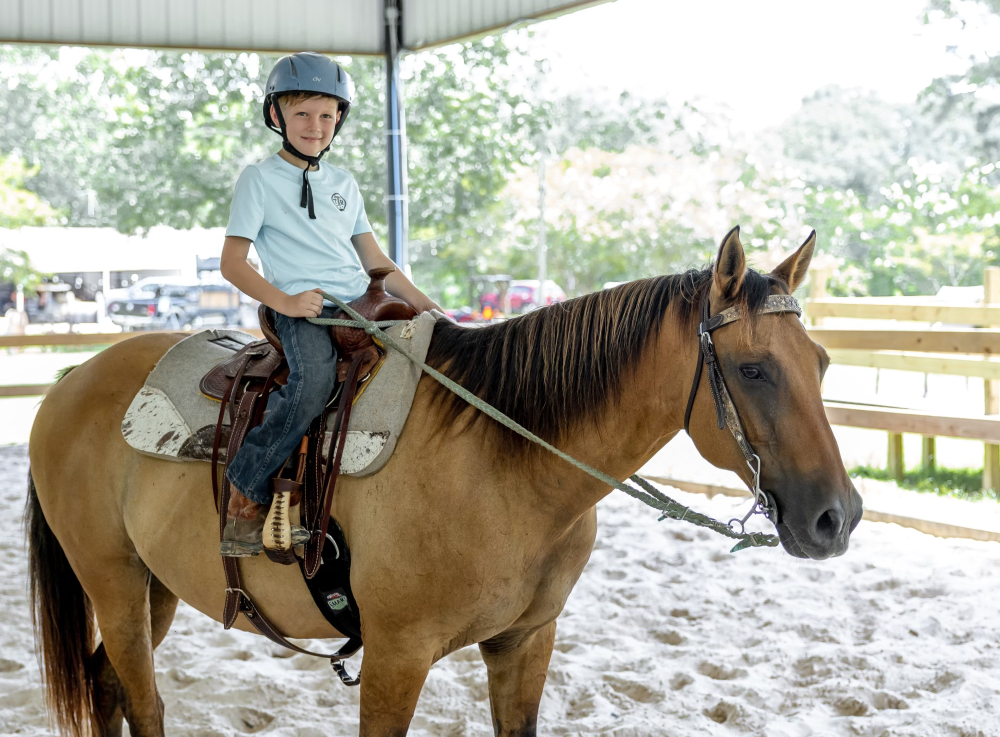 Child riding a horse