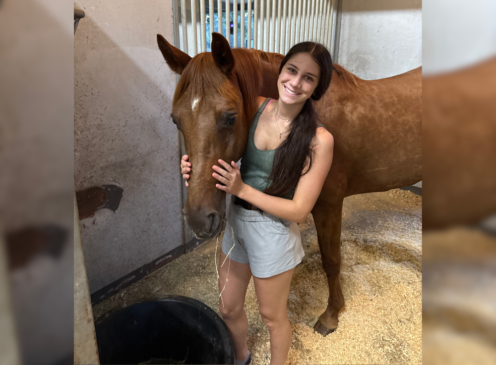 Horsebackriding instructor poses with horse