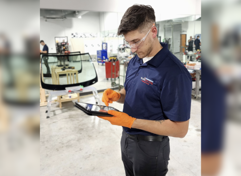 Man looking at ipad in auto shop