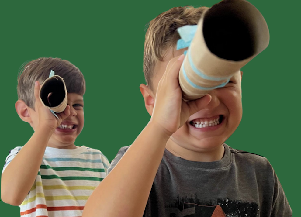 Children looking through paper towel rolls