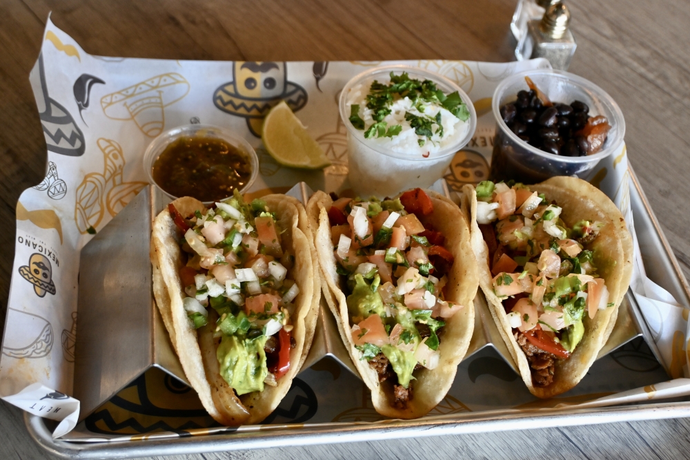 Featured on the Little Mexico section of the menu, the beef tacos order includes three tacos with beans, pico de gallo and guacamole. (Roo Moody/Community Impact)