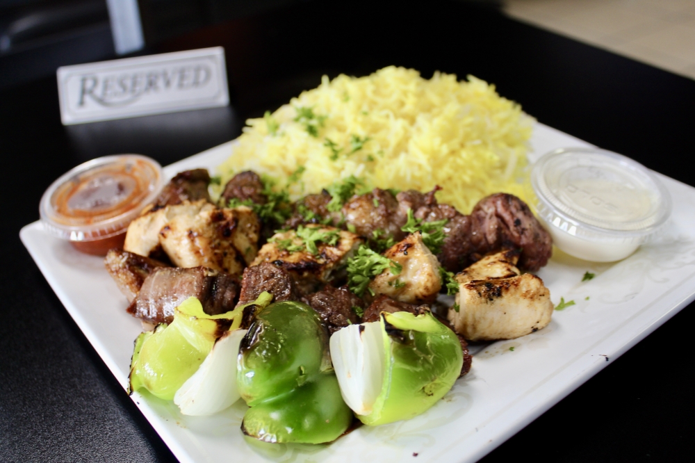 The mixed grill ($19.99) is made with halal lamb, beef and chicken and served with a side of saffron rice. (Jovanna Aguilar/Community Impact)