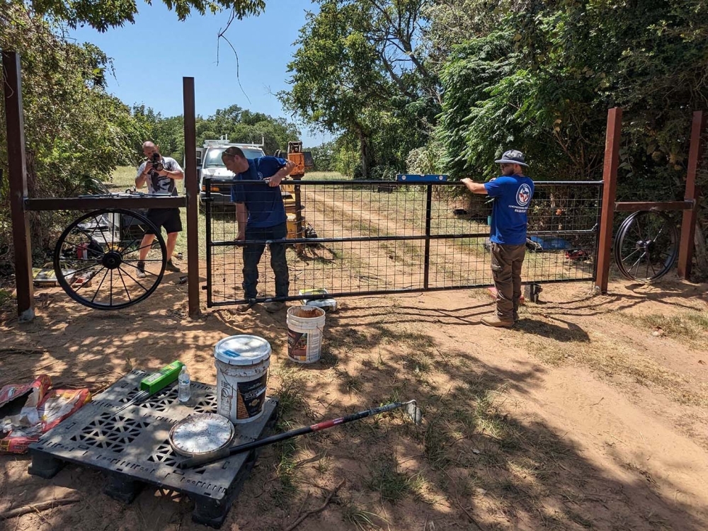 Fence repair contractors fixing fence