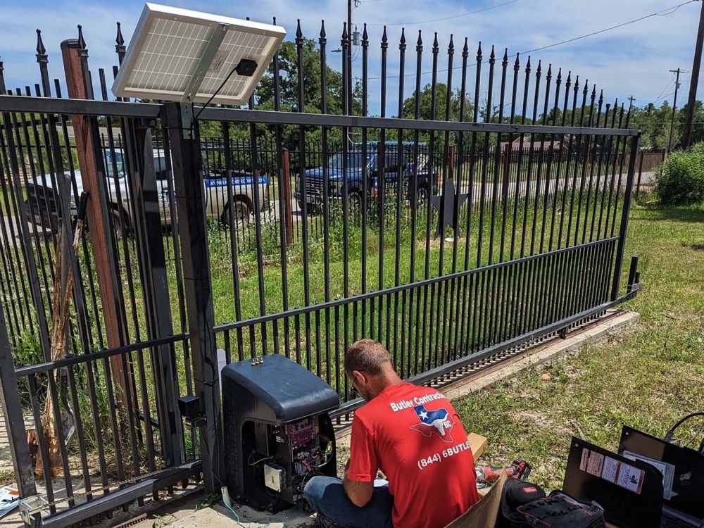 People fixing automatic gate