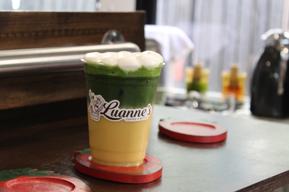 Luanne's Coffee & Matcha serves a honey cornbread matcha latte with corn soy milk, honey vanilla syrup and a cream top. (Chloe Young/Community Impact)