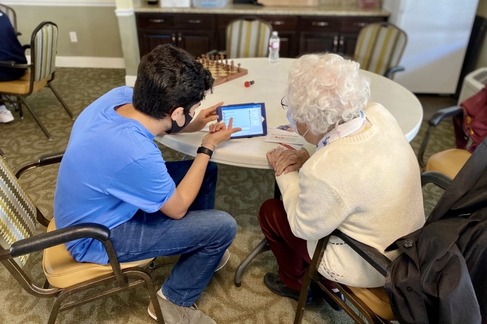 One Silver Heart Care program includes technology classes, where youth volunteers travel to senior homes, showing them how to use their devices. (Courtesy Silver Heart Care)