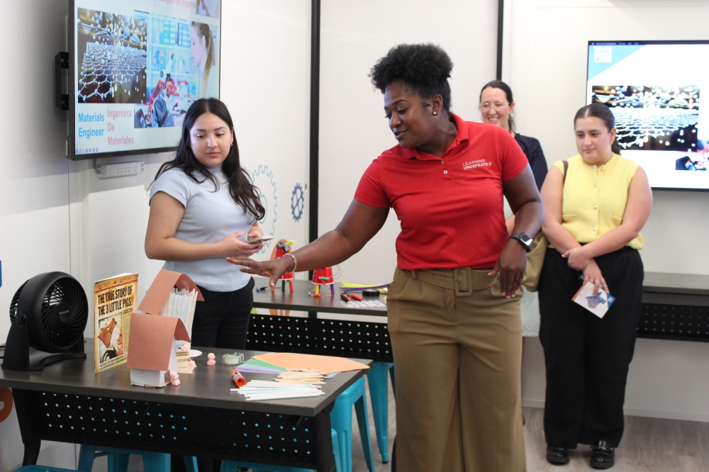 Desurae Matthews, Learning Undefeated’s senior education program manager, showcased hands-on activities students may complete to learn engineering design at the mobile STEM labs. (Chloe Young/Community Impact)
