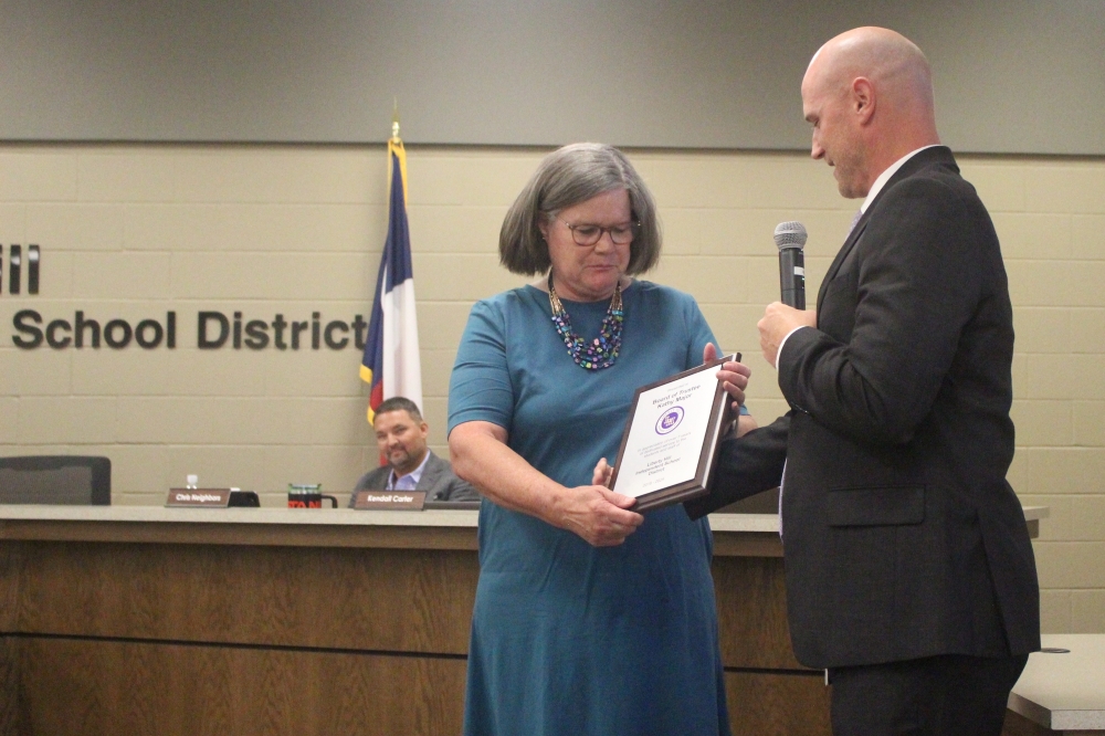 Interim Superintendent Travis Motal recognized former Place 4 trustee Kathy Major for seven years of service on the board at an Aug. 18 meeting. (Chloe Young/Community Impact)