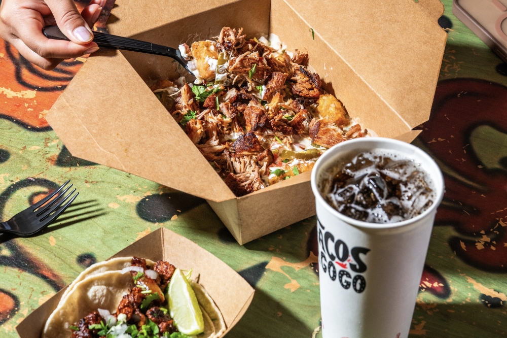 Alongside tacos, Tacos A Go Go's menu includes house-made chips and dips, quesadillas, birria and totchos, Mexican tater tots topped with queso, black beans and sour cream. (Courtesy Dylan McEwan)