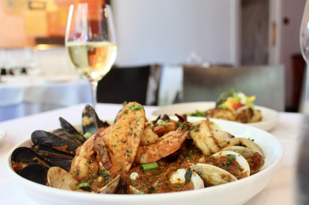 The Snapper Amerigo's ($55) is the restaurant’s signature menu item and is made with a red gulf snapper, sautéed jumbo lump crab, tomatoes, lemon garlic chardonnay sauce, and topped with crisp leeks. (Jovanna Aguilar/Community Impact)