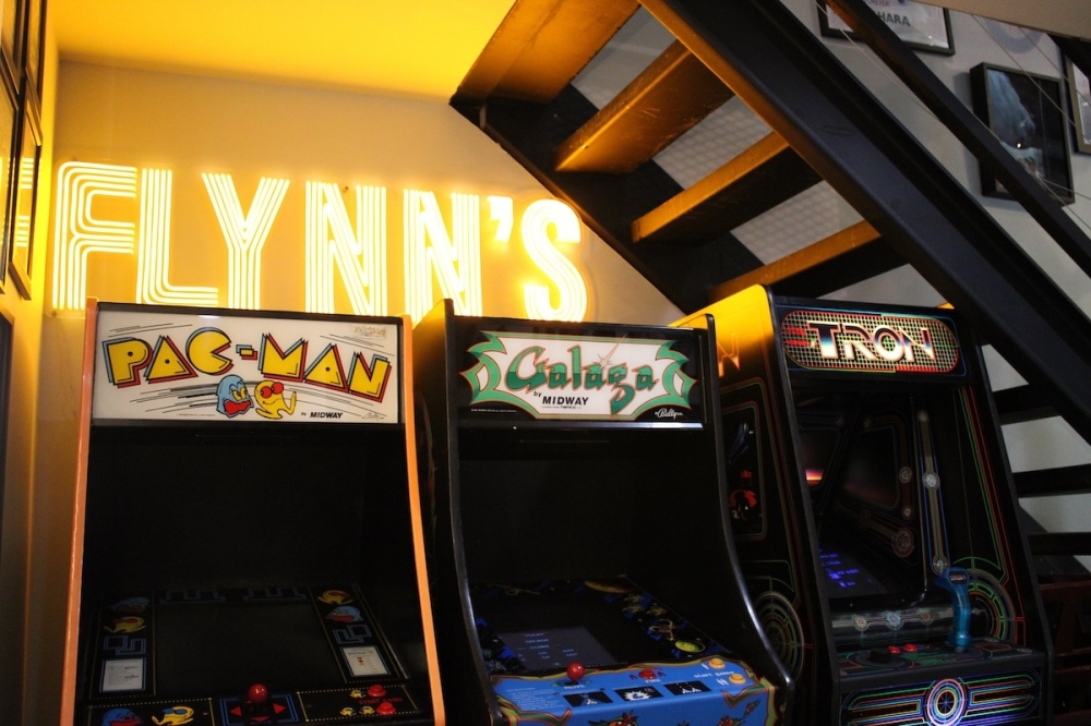 Every nook and cranny of the restaurant is popping with nostalgia, like these retro arcade cabiinets tucked underneath the restaurant's stairwell. (Andrew Creelman/Community Impact)