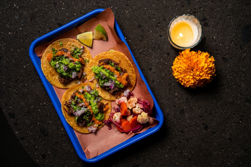 Diners can pair their cocktails with tacos featuring fillings such as carnitas, barbacoa and fish. (Courtesy La Mezca/Photo by Frida Molina)