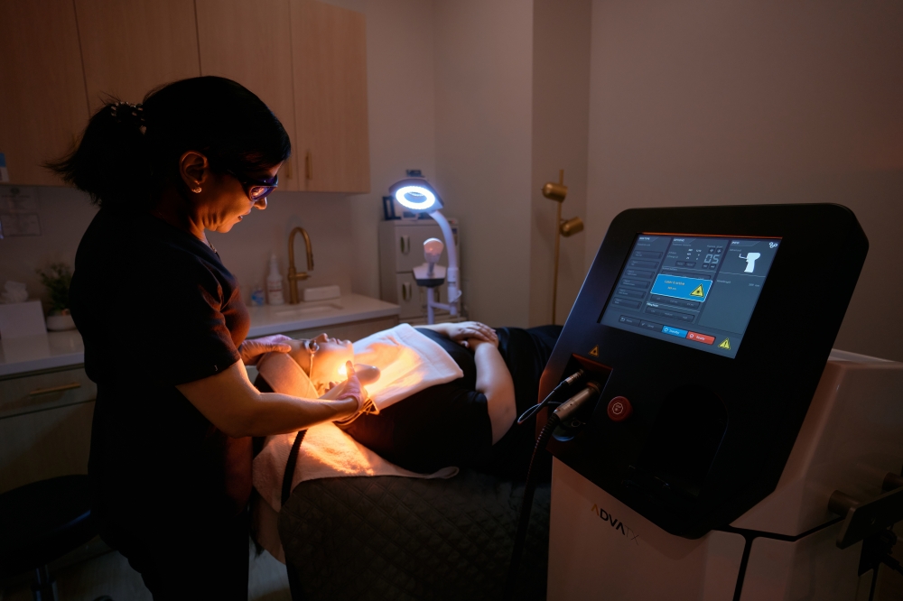 Esthetician performing laser facial in Austin