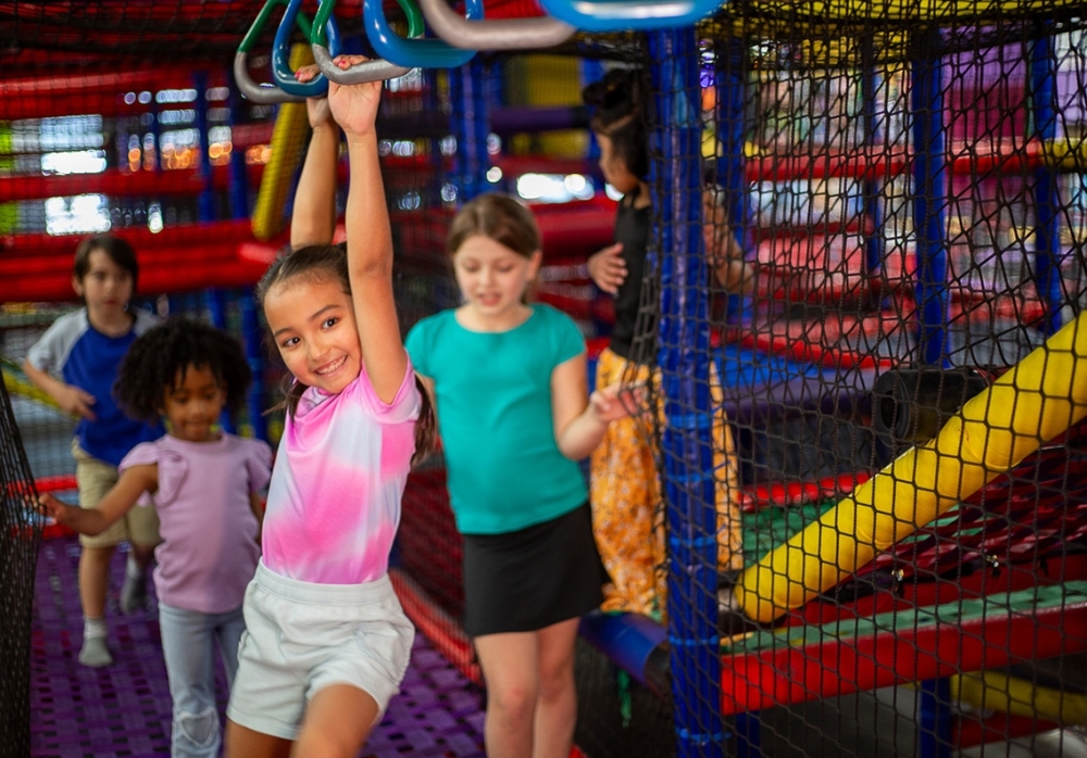 Child playing on monkey bars in Austin