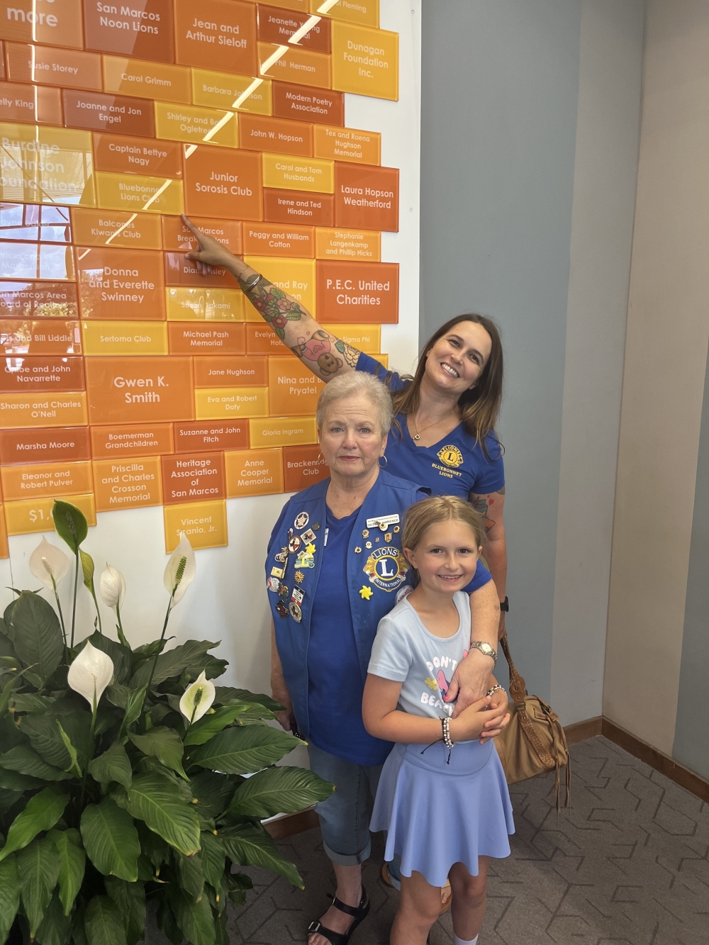 The Feeling Fresh Project Founder and President Paige Biersdorfer (middle) poses with her daughter Wren (right) and Debby Lawrence (left) at the library. (Courtesy The Feeling Fresh Project)