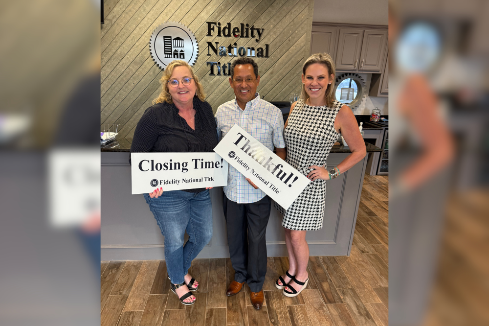 Home closing photo with realtor in DTX