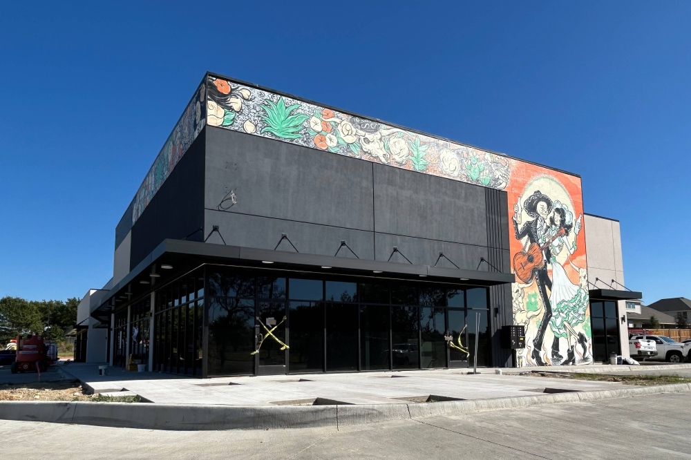 Muralist Mike Kotlarek painted the mural on the future Barrio Tacos + Tequila + Whiskey McKinney location. Kotlarek said he will also paint a mural inside and create repurposed metal art for the exterior and interior. (Karen Chaney/Community Impact)