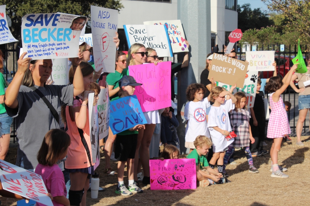 Families of 13 campuses slated for closure next school year rallied at the Austin ISD headquarters before the Oct. 9 board meeting. (Chloe Young/Community Impact)