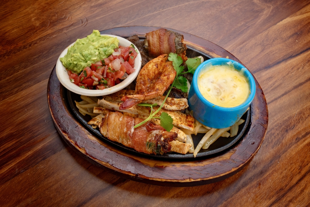 The Don Juan Special made with beef and chicken fajitas, chicken diablo, shrimp brocheta, grilled shrimp and queso and served with guacamole, pico de gallo, charro beans rice and tortillas. (Courtesy Mi Rancho Mexican Grill & Bar )