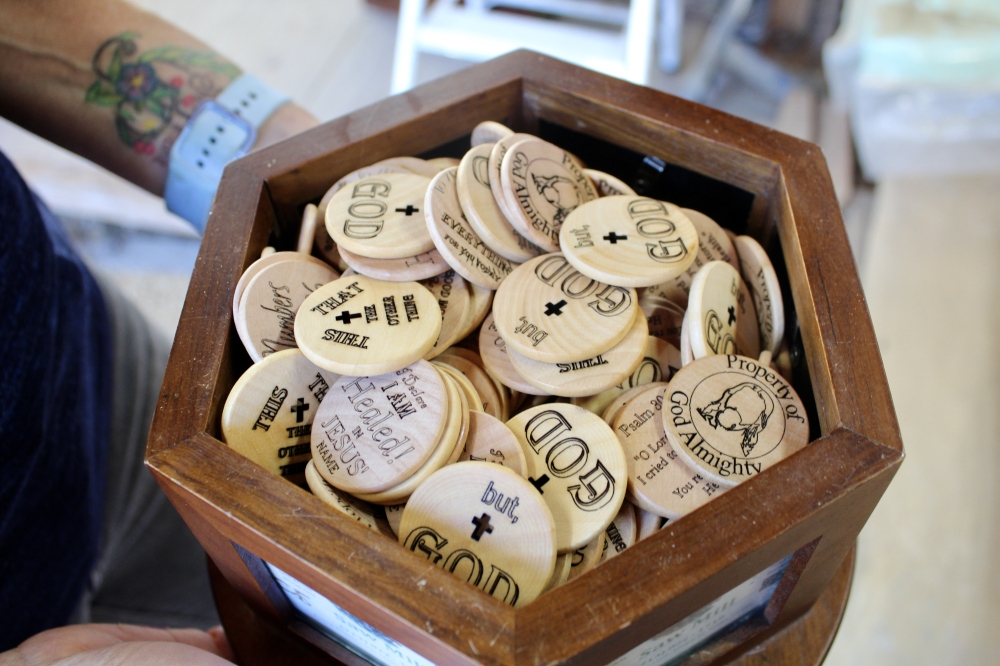 The Jamison's create create tokens carved with biblical phrases and gift them to people as well as local churches. (Jovanna Aguilar/Community Impact)