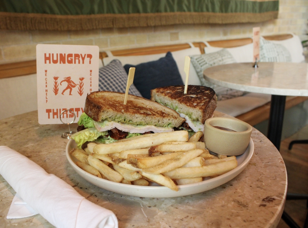 The Carpenter Club includes smoked turkey, crispy bacon, lettuce, tomato, mojo aioli, sourdough and fries for $23. (Dacia Garcia/Community Impact)