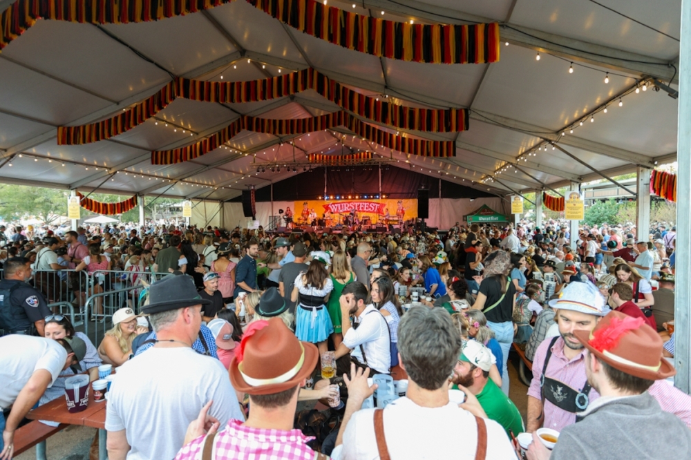 Wurstfest 2025 attendees watch performers on the main stage on the first Saturday of the event. (Ethan Thomas/Community Impact)