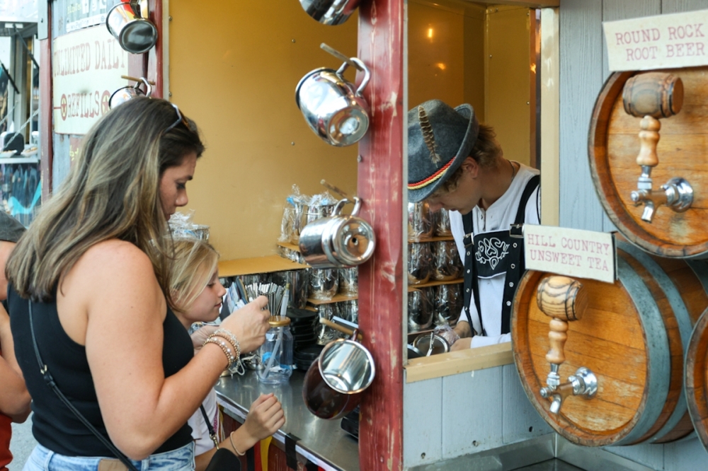 Pecos Pete's All Natural Tea & Soda sells collectible mugs and jars to Wurstfest 2025 attendees. (Ethan Thomas/Community Impact)
