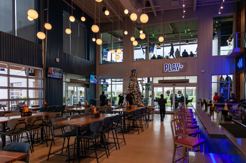 The two-story venue contains a bar, restaurant, pro shop and 62 climate-controlled hitting bays. (Ethan Thomas/Community Impact)