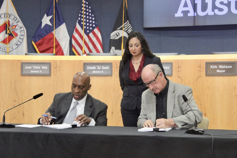 City Manager T.C. Broadnax and Austin Firefighters Association President Bob Nicks signed a new labor deal for firefighters Dec. 18. (Ben Thompson/Community Impact)