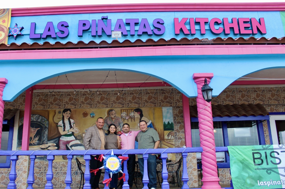 Sergio Aguilera, Vianey Aguilera,Alfredo Pineda and Jose Aguilera stand together outside the family operated restaurant. (Jovanna Aguilar/Community Impact)