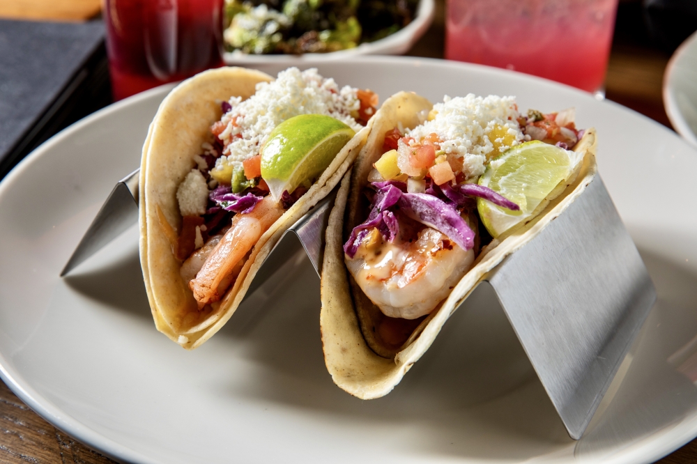 The shrimp tacos ($14) include grilled shrimp topped with purple slaw, queso fresco, pineapple pico, lime and sweet tangy dynamite sauce. (Courtesy On the Kirb)