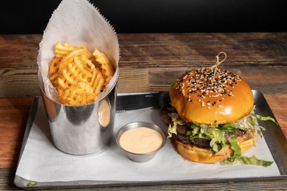 The prime beef cheeseburger ($16), made with a tri-blend of brisket, chuck and short rib and served with a side of truffle fries, is among the eatery's most ordered entrees. (Courtesy Spectators Bar & Grill)