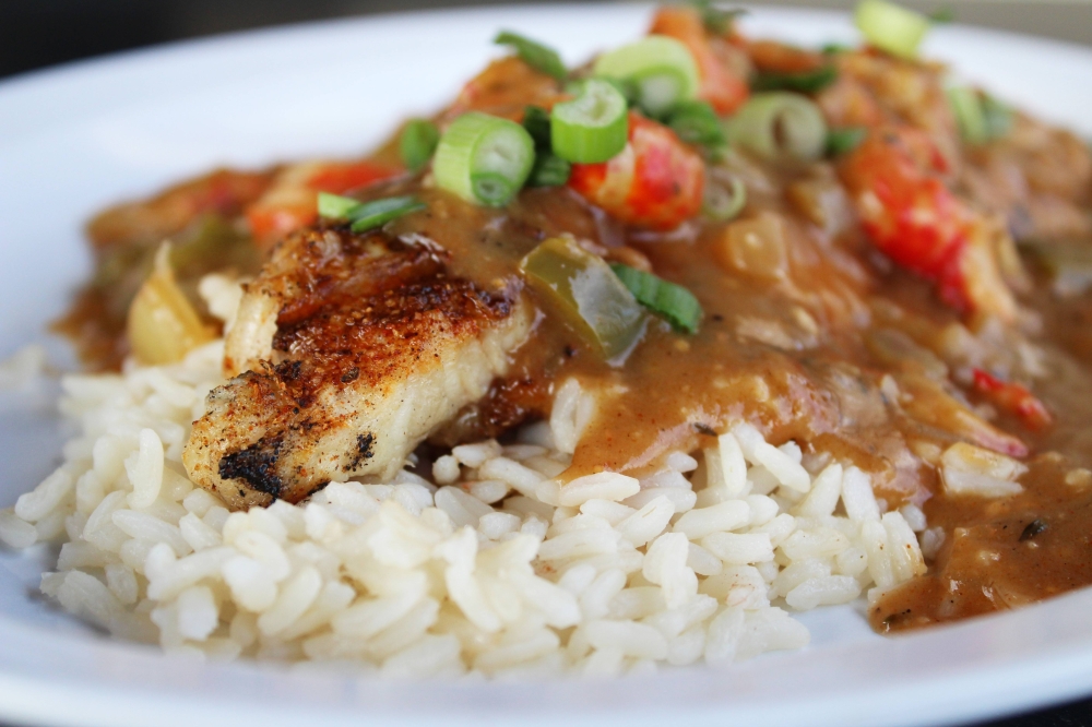 Cajun Tricky Fish ($22.95) features blackened catfish served over white rice, topped with crawfish étouffée. (Karen Chaney/Community Impact)
