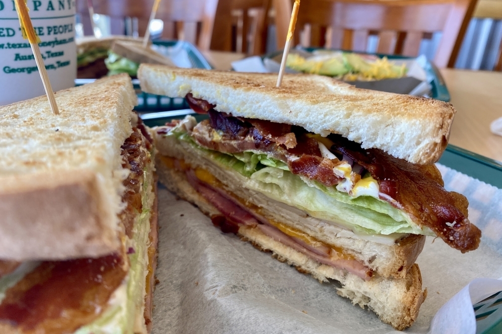 The best selling menu item at Texas Honey Ham's Georgetown location is the club sandwich with ham, turkey, bacon, swiss, cheddar, lettuce, tomato, red onion, mustard, mayo and three slices of bread. (Katlynn Fox/Community Impact)