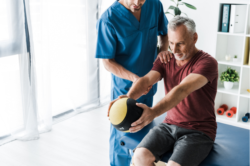Physical therapist working with patient